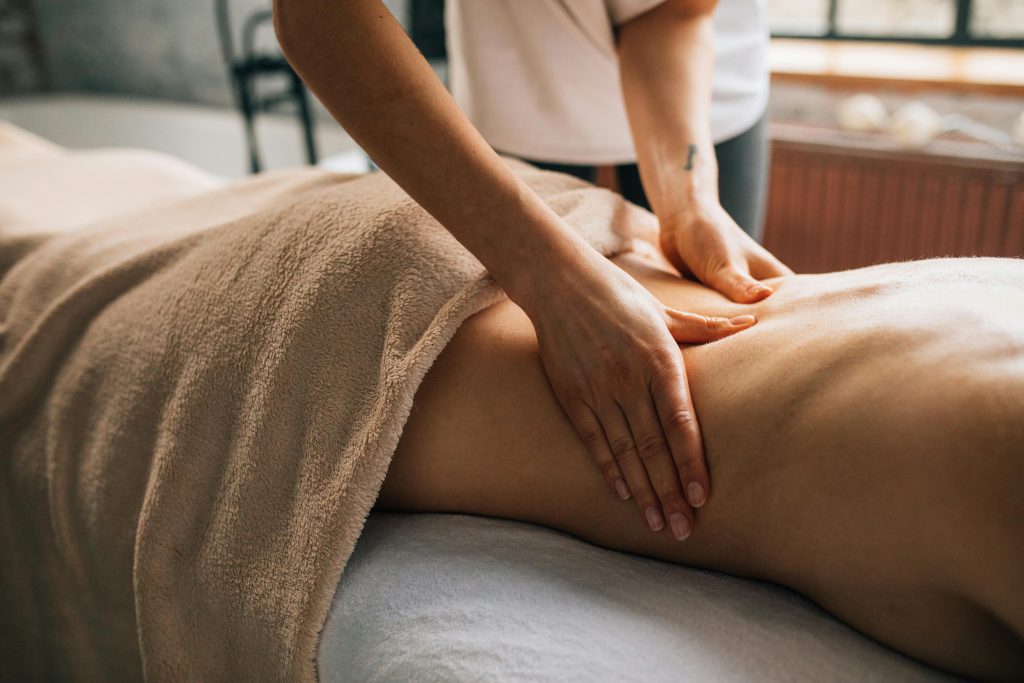 A serene relaxing massage session indoors highlighting hands-on body care and relaxation.
